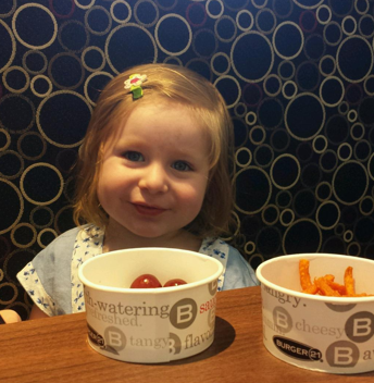 I don’t have any recent photos of Avery eating hot dogs, so here is one of her eating grapes and sweet potato fries.