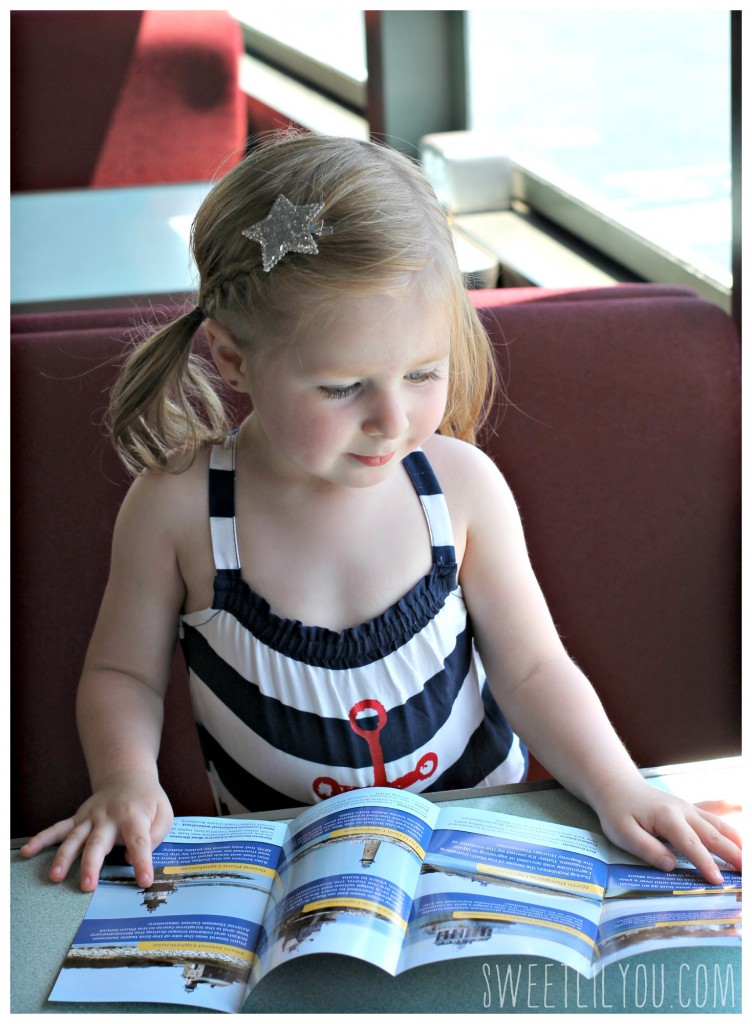 Avery reading the lighthouse cruise brochure